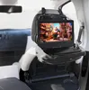 A portable DVD player is mounted on the back of a car seat, playing a movie. Podgląd zdjęcia produktu