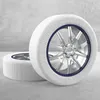 Two snow socks on car wheels, placed on a concrete floor against a concrete wall. Náhled obrázku produktu