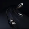 Three charging cables with different connectors (USB-C, Lightning, Micro USB) are shown against a dark, abstract background with light streaks suggesting motion. Produktbild-Vorschau