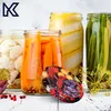 A collection of jars filled with pickled vegetables and a lid with a fruit mix pattern. Podgląd zdjęcia produktu