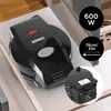 A black Duronic omelette maker is placed on a white surface, possibly a drawer, with some marketing text overlays showing power and dimensions. Produktbild-Vorschau