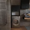 A modern bathroom with a washing machine, cabinets, and a towel rack. Podgląd zdjęcia produktu
