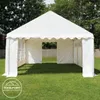 A white party tent is set up on a green lawn with trees in the background. Voir les images du produit
