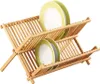 A two-tiered bamboo dish rack holding several plates. Náhľad obrázku produktu