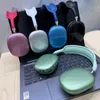 Several colorful headphones are displayed on top of a laptop. Produktbild-Vorschau