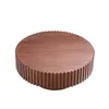 A round wooden coffee table with a fluted base, shown against a white background. Produktbild-Vorschau