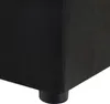 A close-up view of the corner of a black upholstered ottoman or footstool, showing one of its black cylindrical feet. Podgląd zdjęcia produktu