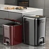 Two pedal trash cans are placed on a kitchen floor next to a kitchen island. Produktbild-Vorschau