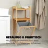 A bamboo laundry shelf with a removable laundry basket in a bathroom setting. Podgląd zdjęcia produktu