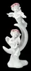 A white figurine of two cherubs playing musical instruments on a crescent moon, set against a black background. Produktbild-Vorschau