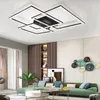 A modern living room with a green sofa, coffee table, and decorative wall art, featuring a contemporary ceiling light. Voir les images du produit