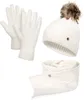 A set of winter accessories including gloves, a hat with a pom-pom, and a scarf, all in white. Produktbild-Vorschau