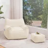 A beige beanbag chair and ottoman are placed in a well-lit room with a large window overlooking trees and houses. Náhled obrázku produktu