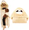 A woman wearing a sloth-themed hooded blanket and a separate sloth-themed pillow. Produktbild-Vorschau