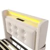 Close-up view of a beige upholstered bed headboard with integrated LED lighting and a charging port. Produktbild-Vorschau