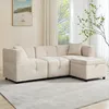 A beige sectional sofa with a storage ottoman is shown in a well-lit living room with sheer curtains in the background. Voir les images du produit