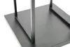 A close-up view of the base of a black metal firewood rack. Produktbild-Vorschau