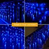 A collage of four images showing blue icicle-shaped string lights, some draped over railings and stairs, with a yellow banner in the center. Produktbild-Vorschau