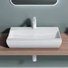A white ceramic vessel sink with a modern faucet sits on a wooden countertop against a light gray wall. Produktbild-Vorschau