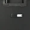 A close-up view of a black suitcase handle and a luggage tag. Náhľad obrázku produktu