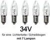 Five clear, candle-shaped light bulbs with silver bases are arranged in a row against a white background. Text below the bulbs indicates their voltage and intended use. Produktbild-Vorschau