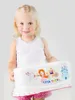 A young girl is holding a white step stool with colorful cartoon graphics. Produktbild-Vorschau