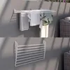 Two wall-mounted drying racks are shown, one with laundry hanging on it, and another empty rack below. Náhľad obrázku produktu