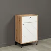 A modern cabinet with a white drawer and a patterned white door, set against a gray wall and light gray floor. Voir les images du produit