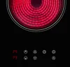A close-up of a black induction cooktop with a glowing red heating element and touch controls. Produktbild-Vorschau