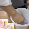 A person's hands are shown interacting with a product in a bucket, with packaging visible in the foreground. Produktbild-Vorschau