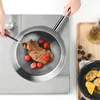 A person is cooking a steak in a stainless steel pan on a stovetop, with cherry tomatoes as a side. Produktbild-Vorschau