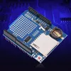 A blue electronic circuit board with various components, including an SD card slot and a battery holder, is shown against a dark blue background with circuit board patterns. Náhled obrázku produktu