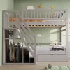 A children's bunk bed with stairs, a wardrobe, and a drawer, set against a light green wall. Náhled obrázku produktu