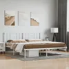 A white metal bed frame with a headboard, dressed with brown and white bedding, is shown in a bedroom setting with artwork on the wall and a lamp in the background. Anteprima dell’immagine prodotto