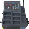 A close-up view of a car wheel balancing machine's control panel and storage compartments. Produktbild-Vorschau