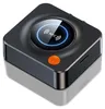 A product shot of a black square electronic device with a circular display and an orange button. Podgląd zdjęcia produktu