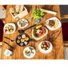 A collection of food items and utensils laid out on a wooden table. Náhled obrázku produktu