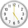 A close-up view of a white analog clock with a silver frame. Produktbild-Vorschau