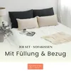 Two dark gray and two beige pillows are arranged on a white bed. Produktbild-Vorschau
