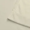 A close-up view of the corner and hem of a cream-colored fabric, likely a curtain or blanket. Produktbild-Vorschau
