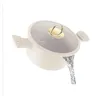 A cream-colored pot with a glass lid and gold accents, with water pouring out of it. Náhľad obrázku produktu