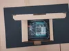 A product is shown inside its packaging, which is placed within a larger cardboard box. Produktbild-Vorschau