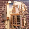 A close-up view of a miniature model of a building, possibly from a Harry Potter-themed set, with an owl perched on a ledge. Produktbild-Vorschau