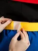 Hands attaching a yellow belt with velcro to a costume. Anteprima dell’immagine prodotto