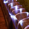 A close-up shot of white LED rope lights wrapped around a wooden railing. Náhled obrázku produktu