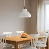 A dining table with chairs and a pendant light. Produktbild-Vorschau