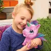 A young girl is happily hugging a pink unicorn toy. Náhled obrázku produktu
