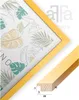 A close-up of a yellow picture frame with a botanical print inside, and a separate image showing a cross-section of the frame's material with dimensions. Produktbild-Vorschau