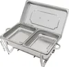 A stainless steel chafing dish with two compartments, shown from a slightly elevated angle with dimensions overlaid. The lid is partially open. Náhled obrázku produktu