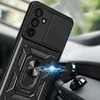 A black phone case with a ring holder is attached to a magnetic car mount on a car dashboard. Náhľad obrázku produktu